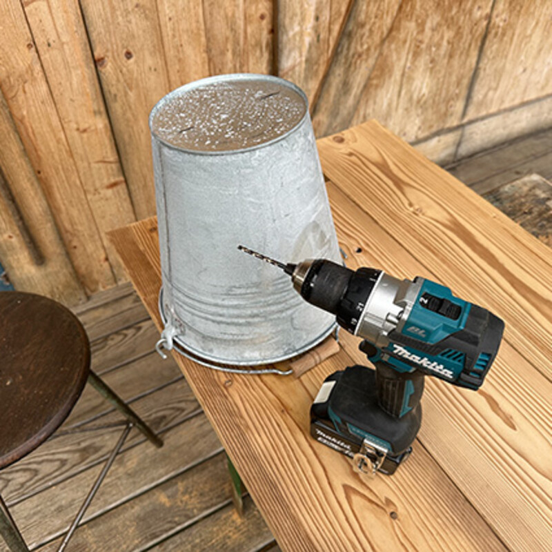 Garten-Organizer bauen: Metalleimer und Bohrmaschine auf Holztisch