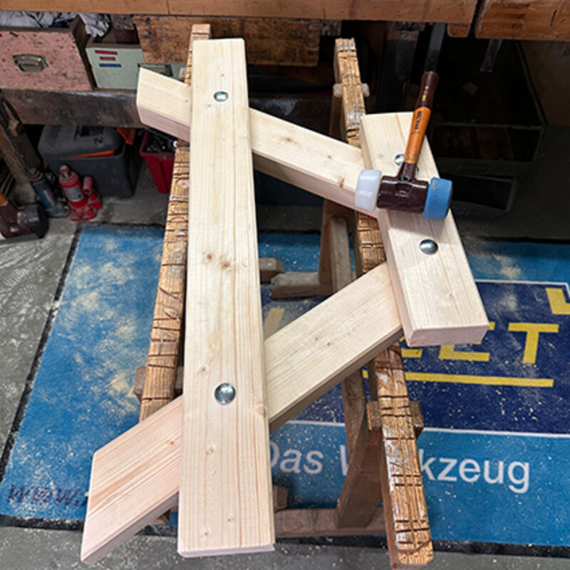 Tisch für Kinder bauen: Holzkontruktion und Hammer in Wekstatt