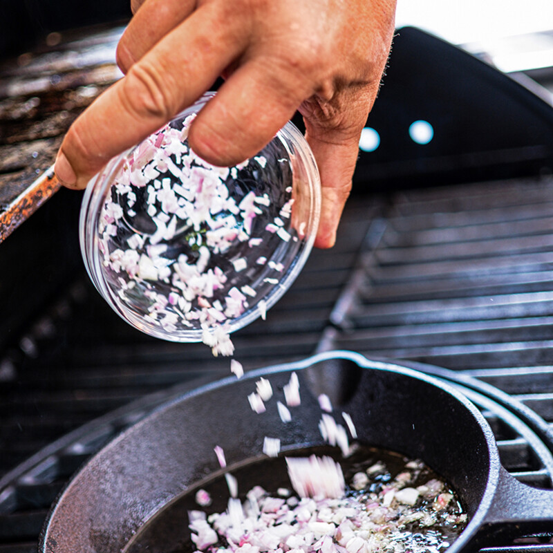 Schalotten und Knoblauch in die Pfanne geben