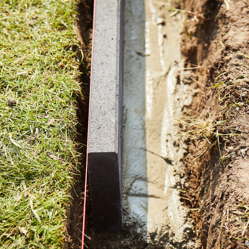 Rasenkantensteine setzen: Steine mit zus&auml;tzlicher Betonschicht stabilisieren